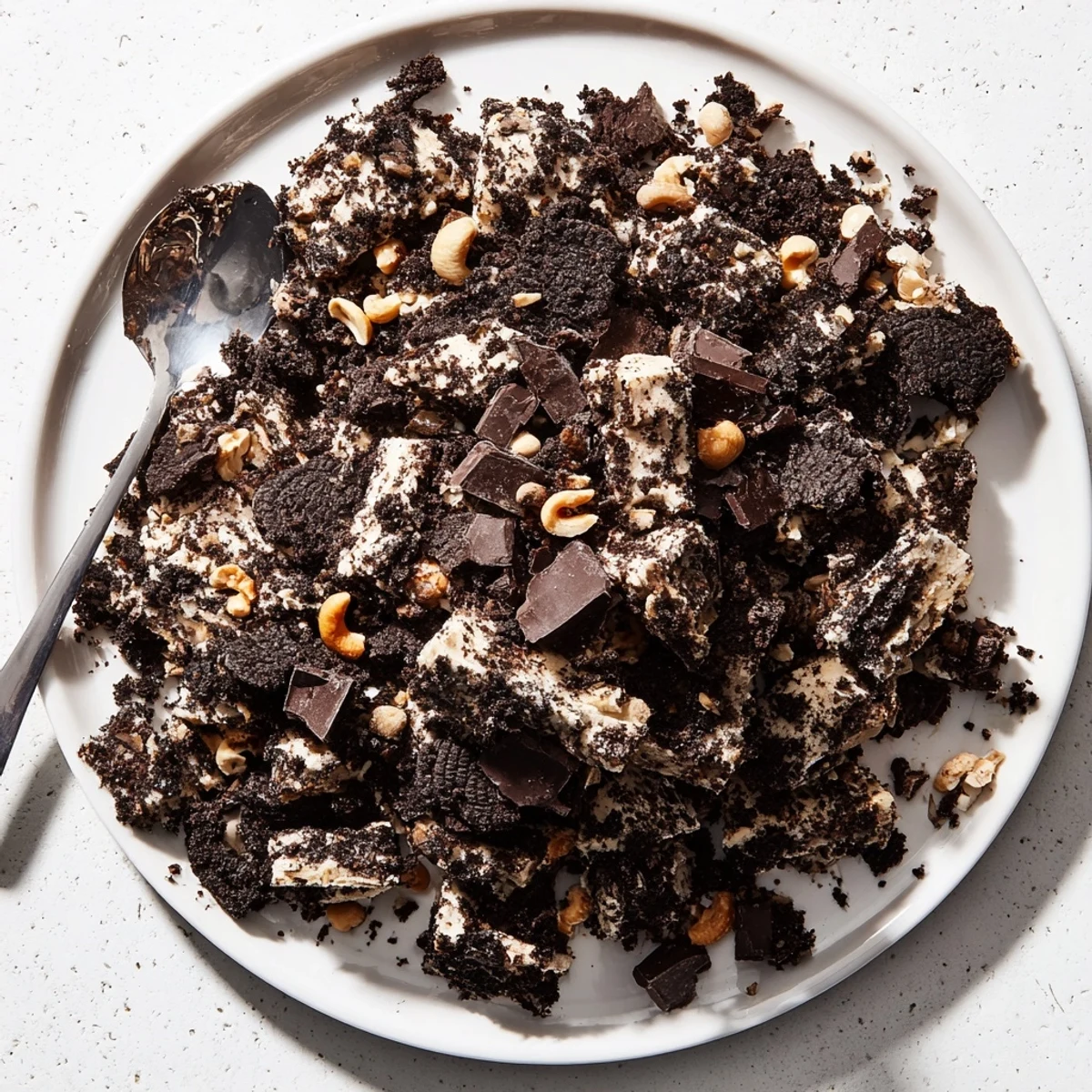 A bowl of rich chocolate cookie crumble made from crushed Oreos and butter, ready to sprinkle on desserts.