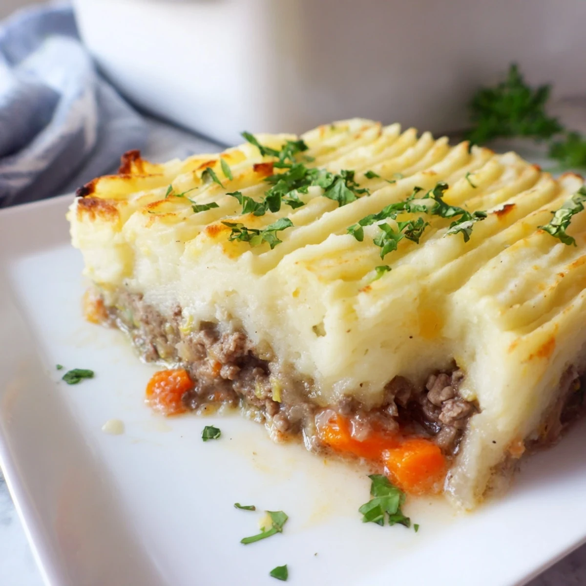 Golden-brown St. Patricks Day Shepherds Pie with lamb filling, served in a rustic dish with steam rising.  