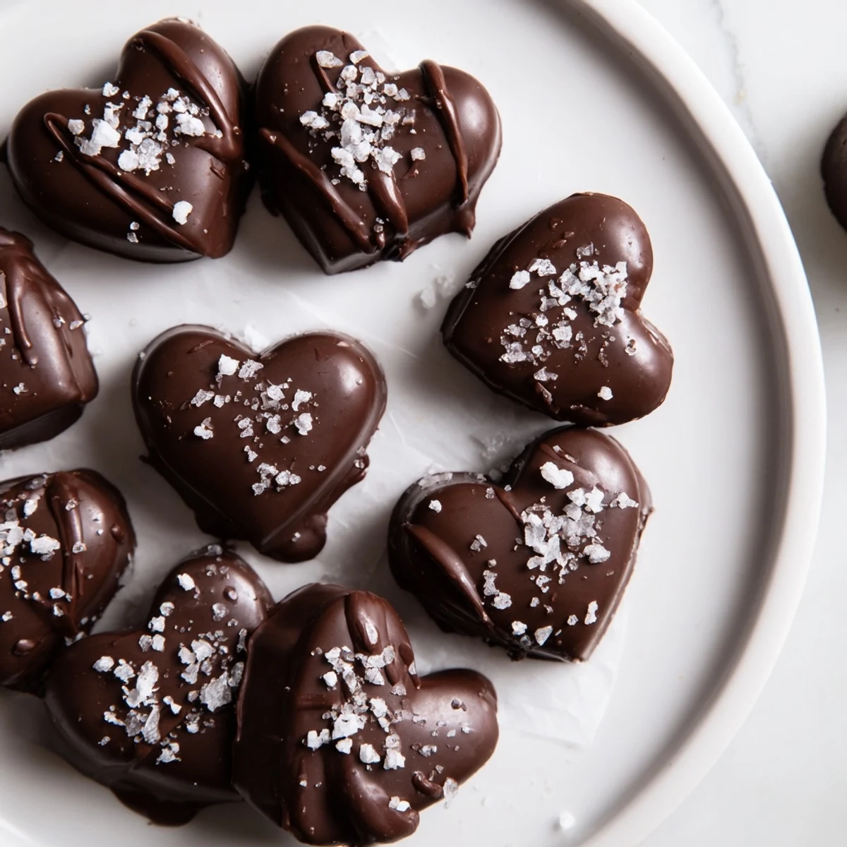 Homemade Chocolate Peanut Butter Hearts arranged on parchment paper, ready to enjoy.