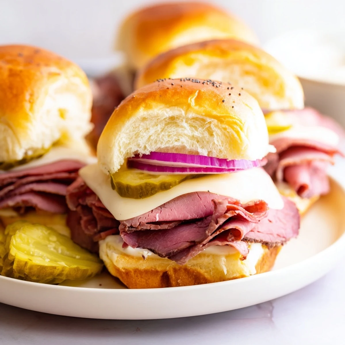 Golden-brown Corned Beef Sliders with melted Swiss cheese and mustard, served warm on a rustic wooden board with fresh dill pickles.  