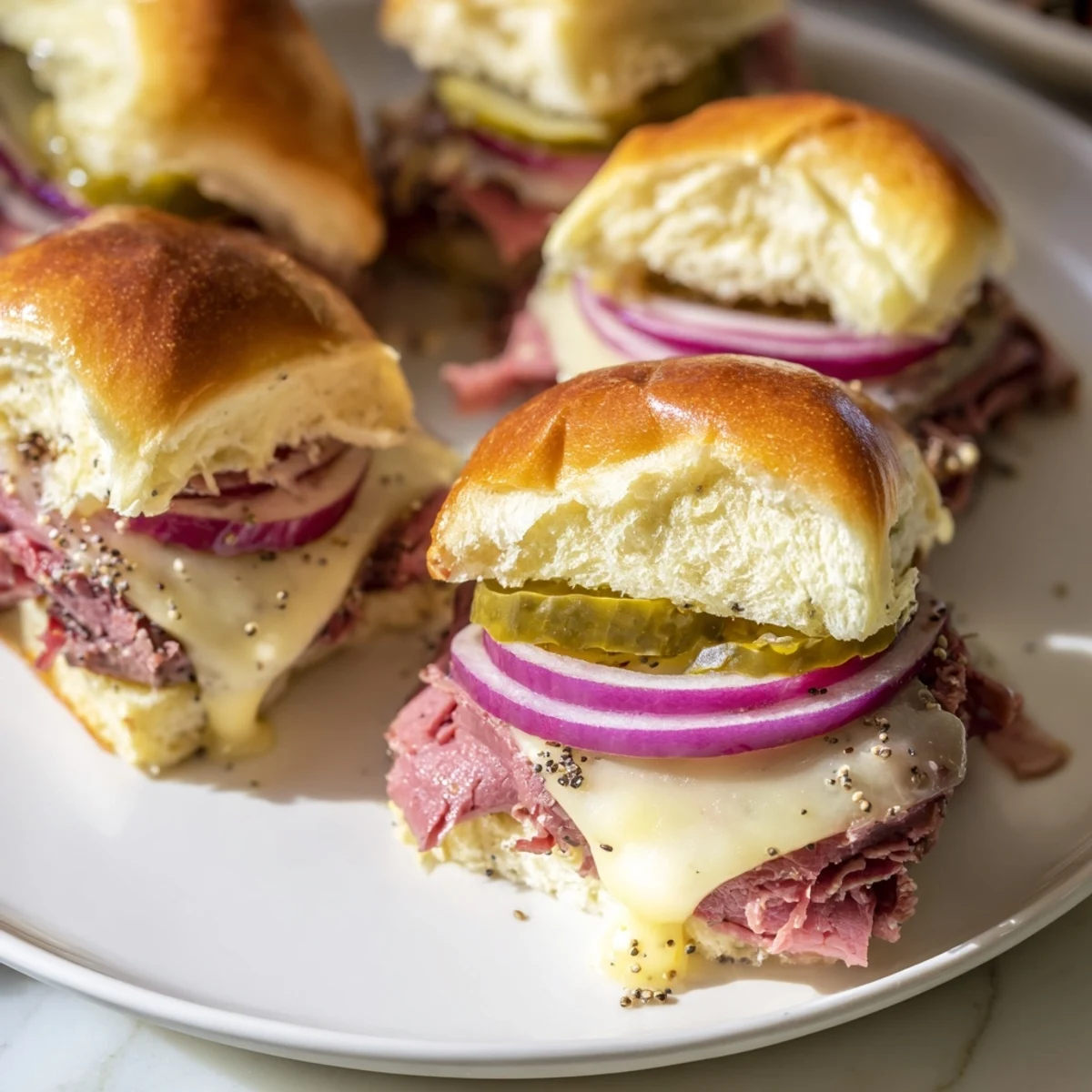 A close-up of Corned Beef Sliders featuring tender corned beef, whole-grain mustard, and Swiss cheese on soft, toasted slider buns.  