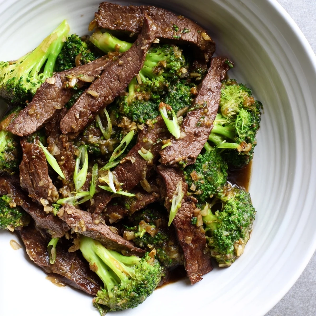 Tender slices of beef and crisp broccoli in a glossy ginger sauce served over steamed jasmine rice in this Beef and Broccoli Stir Fry with Ginger Sauce.