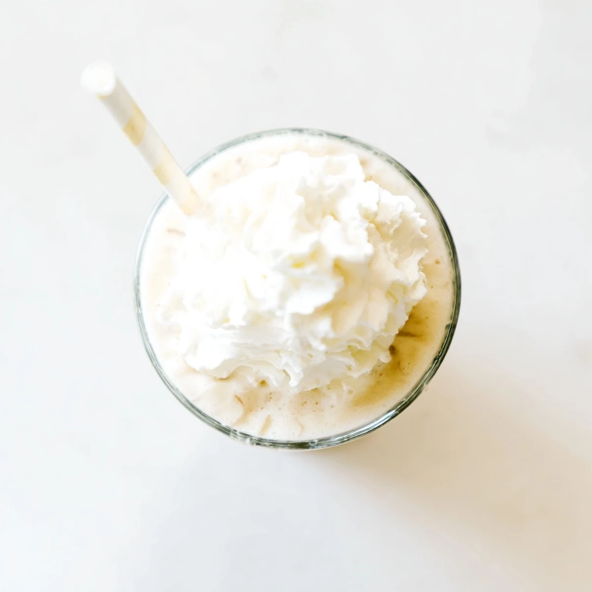 Creamy Starbucks Vanilla Bean Frappuccino topped with whipped cream in a tall glass.