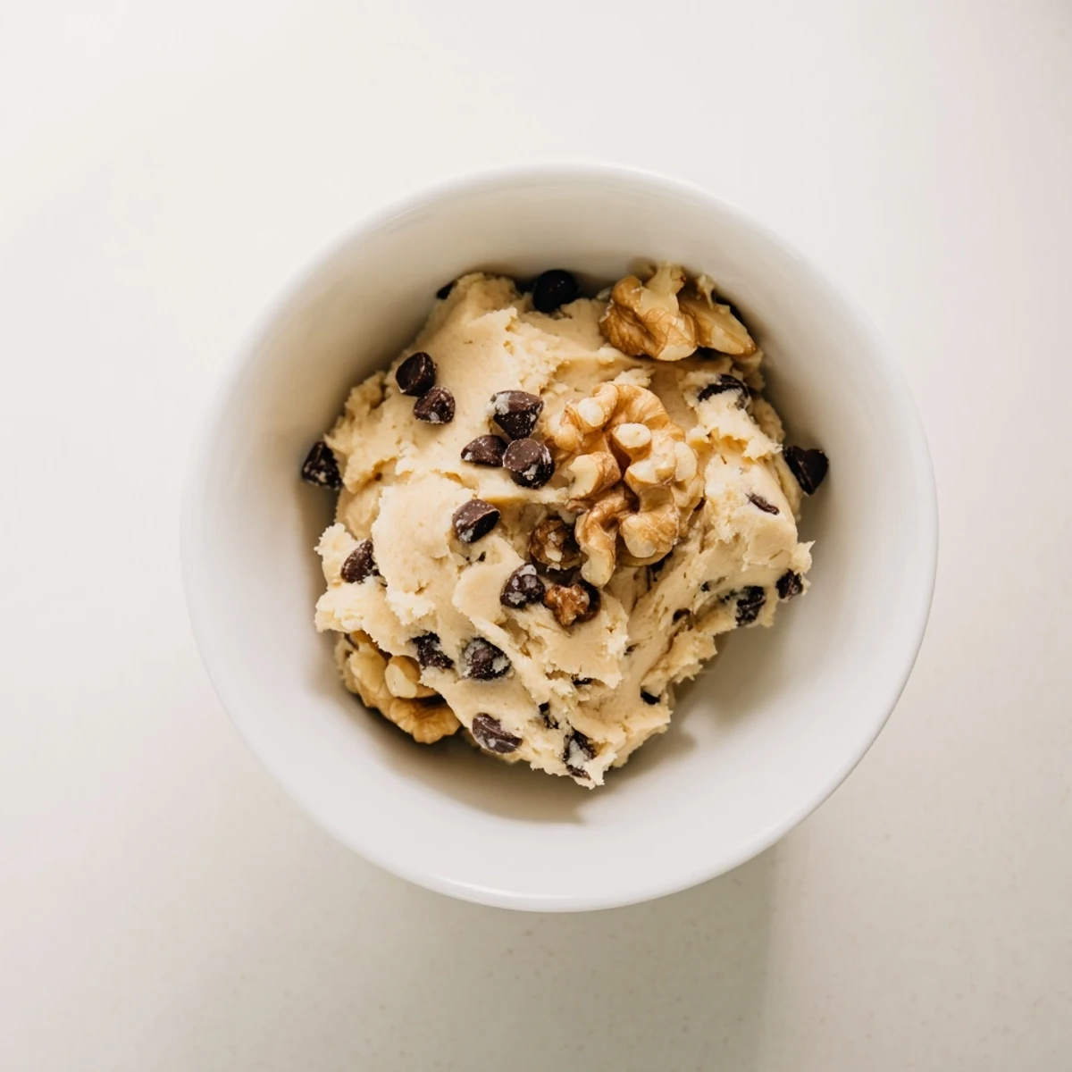Spoon dipping into creamy Guilt Free Greek Yogurt Cookie Dough, showcasing its thick, protein-packed texture and sweet honey aroma.