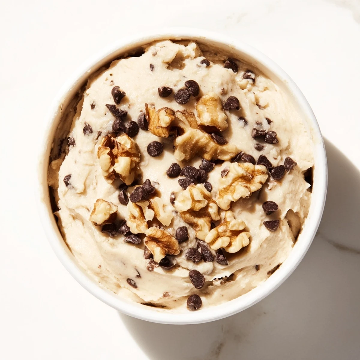 Guilt Free Greek Yogurt Cookie Dough served with apple slices and pretzels on a rustic wooden table, perfect for a healthy snack.