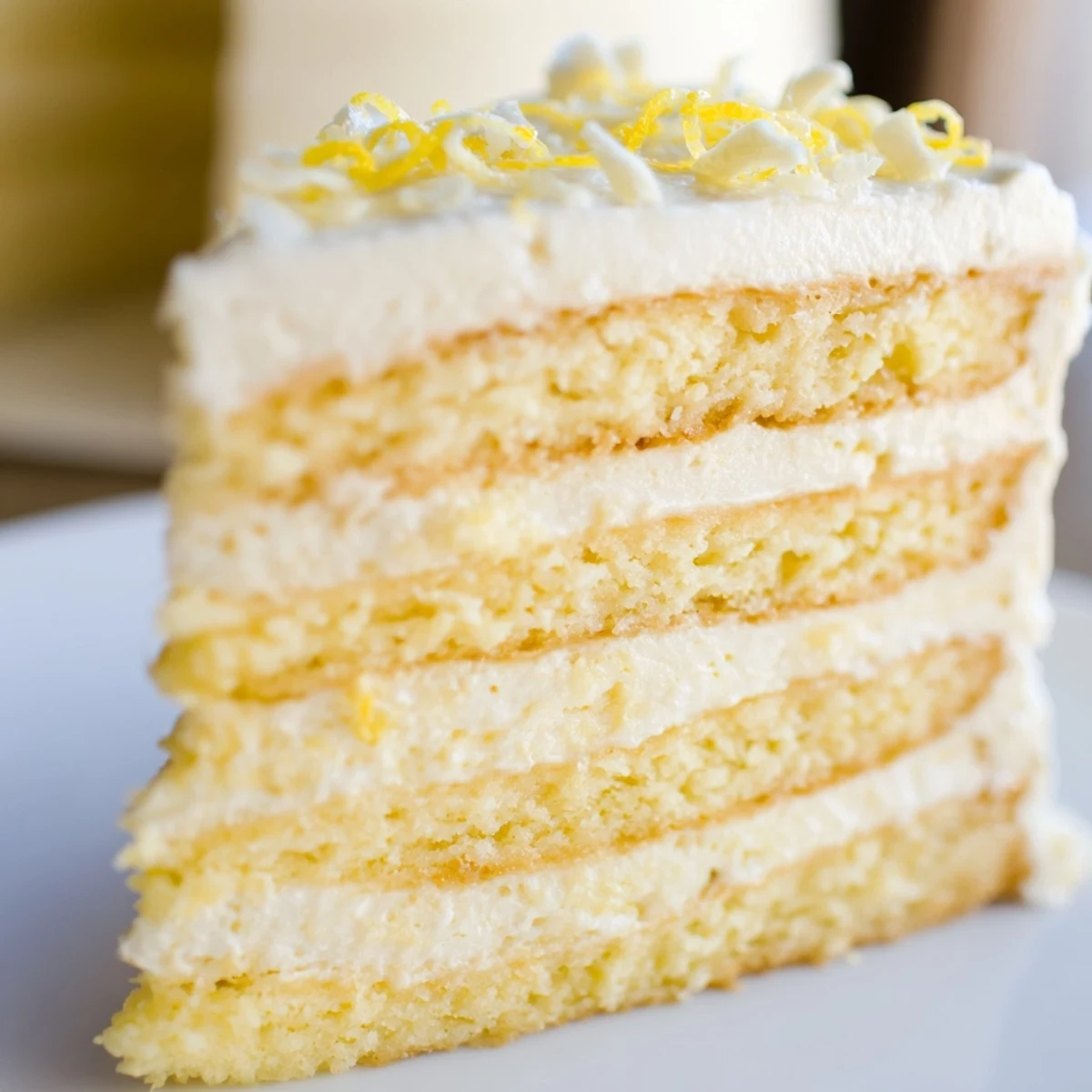 Golden layers of Limoncello Mascarpone Cake showcasing a light sponge soaked in syrup and creamy mascarpone frosting.