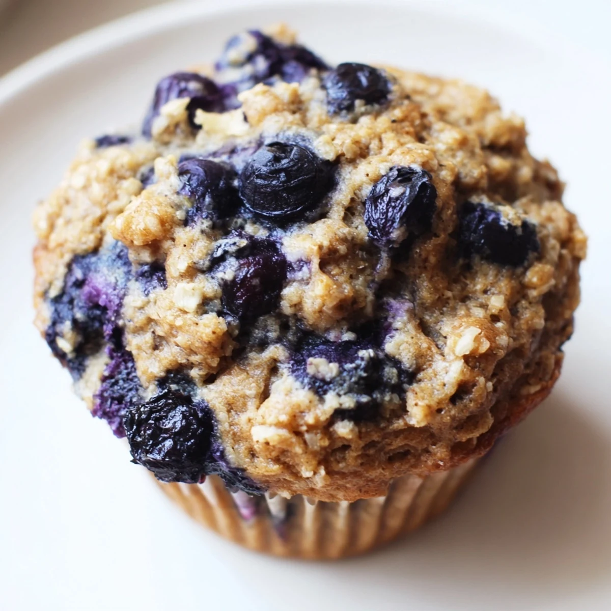 Golden-brown Greek Yogurt Blueberry Protein Muffins cooling on a rack after baking.  
