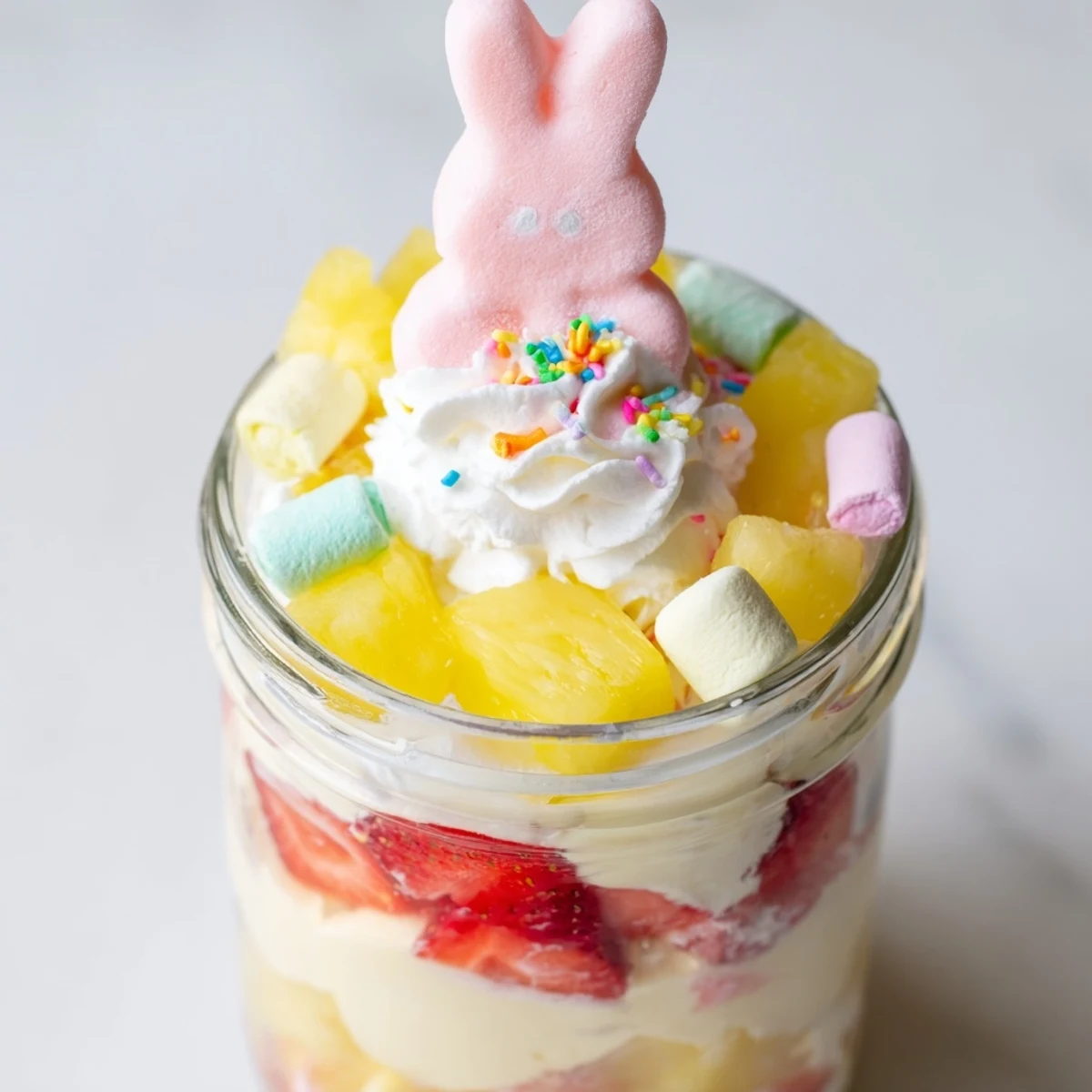 Festive Jello Pie Easter Bunny Parfait In A Jar with creamy layers and pastel sprinkles.