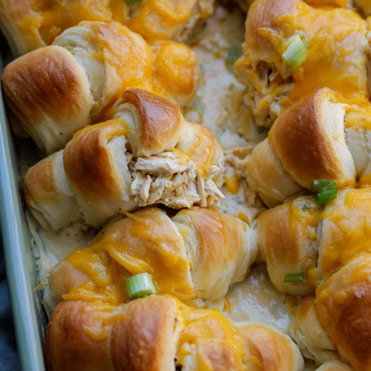 Golden brown Cheesy Chicken Crescent Bake with bubbling mozzarella cheese topping on flaky crescent rolls