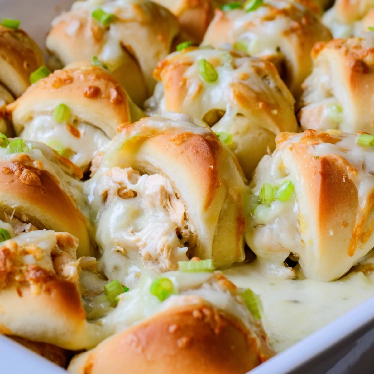 Baked crescent rolls stuffed with seasoned chicken and cheddar cheese, served warm from the oven