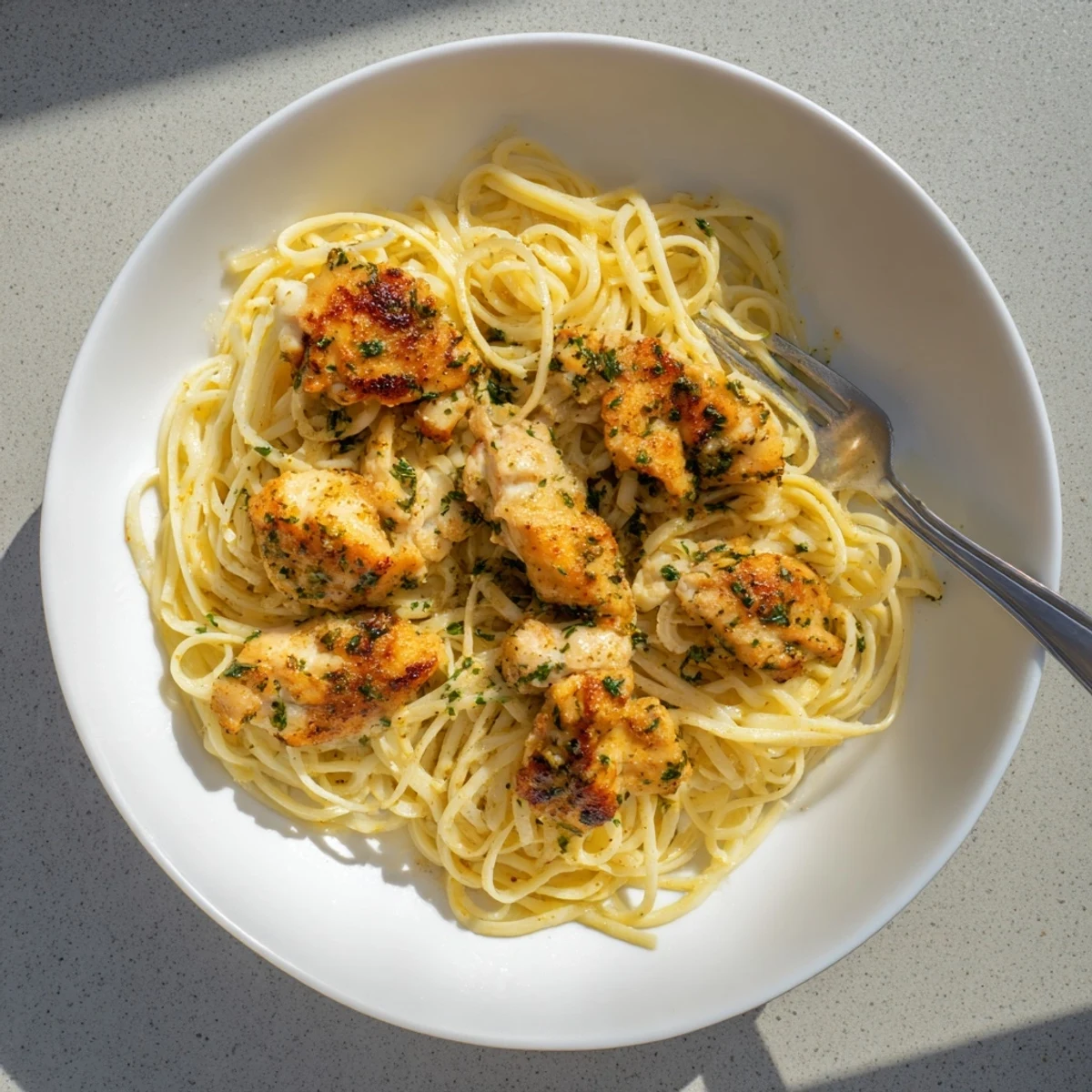 Savory seasoned chicken nestled atop silky noodles in this easy one pan dinner