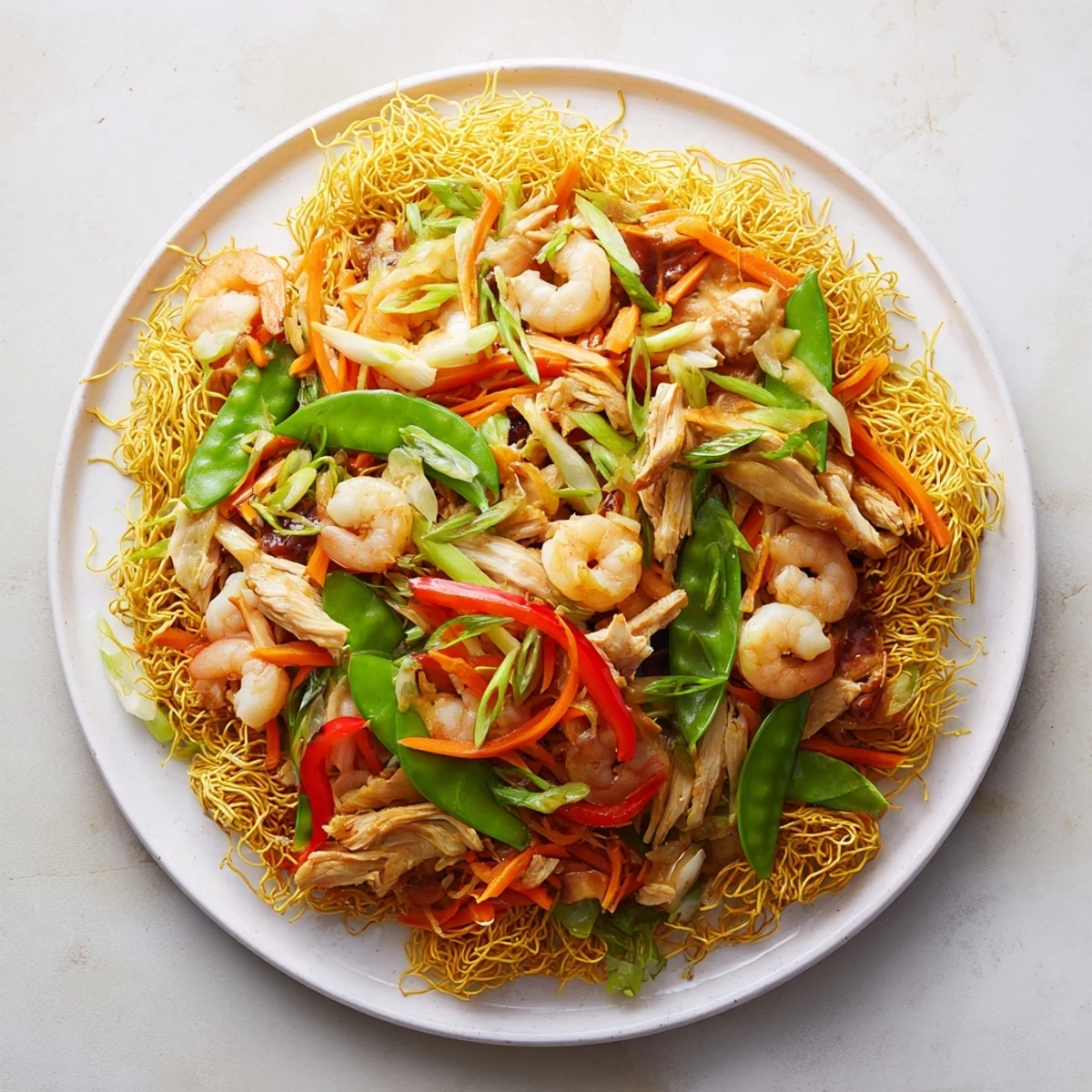 Golden stir-fried noodles piled high with char siu pork, bean sprouts, and snow peas in glossy sauce