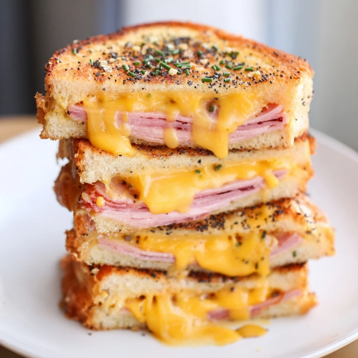 Buttery grilled Hawaiian roll sliders stuffed with ham and cheese on a wooden serving board