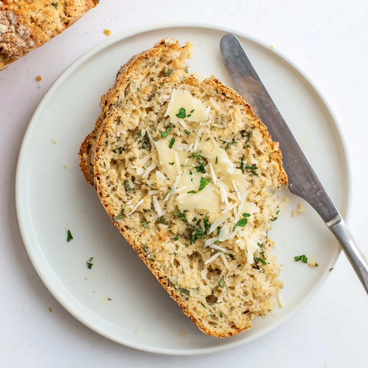 Savory low-carb almond flour bread slices featuring golden crust and aromatic dried herbs
