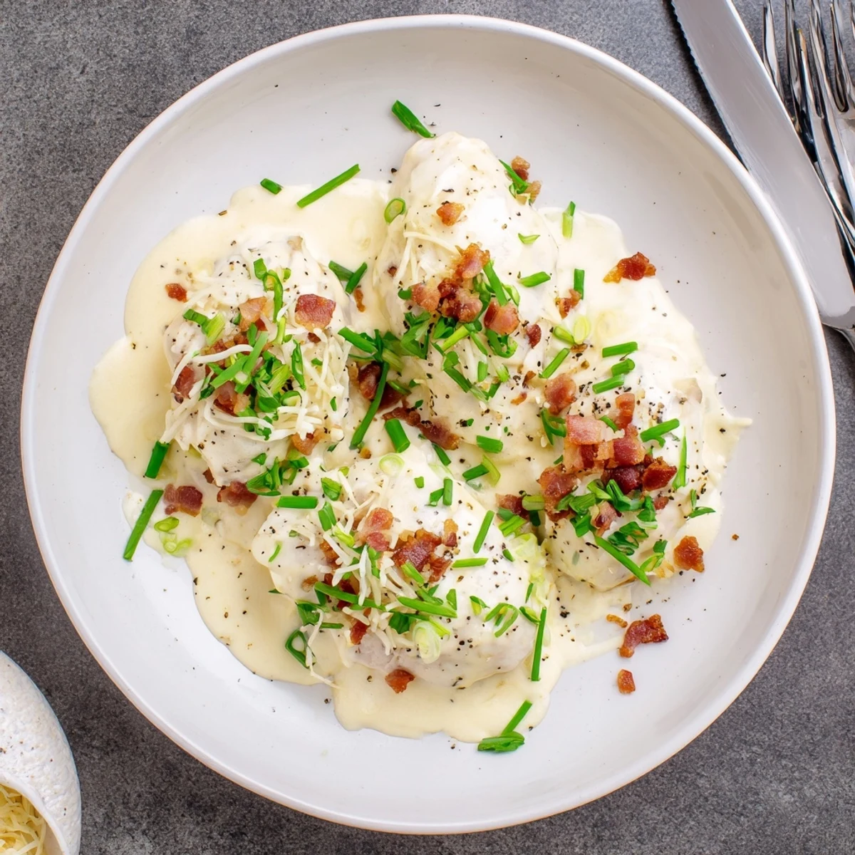 Creamy slow cooked Million Dollar Chicken with melted mozzarella and fresh herbs