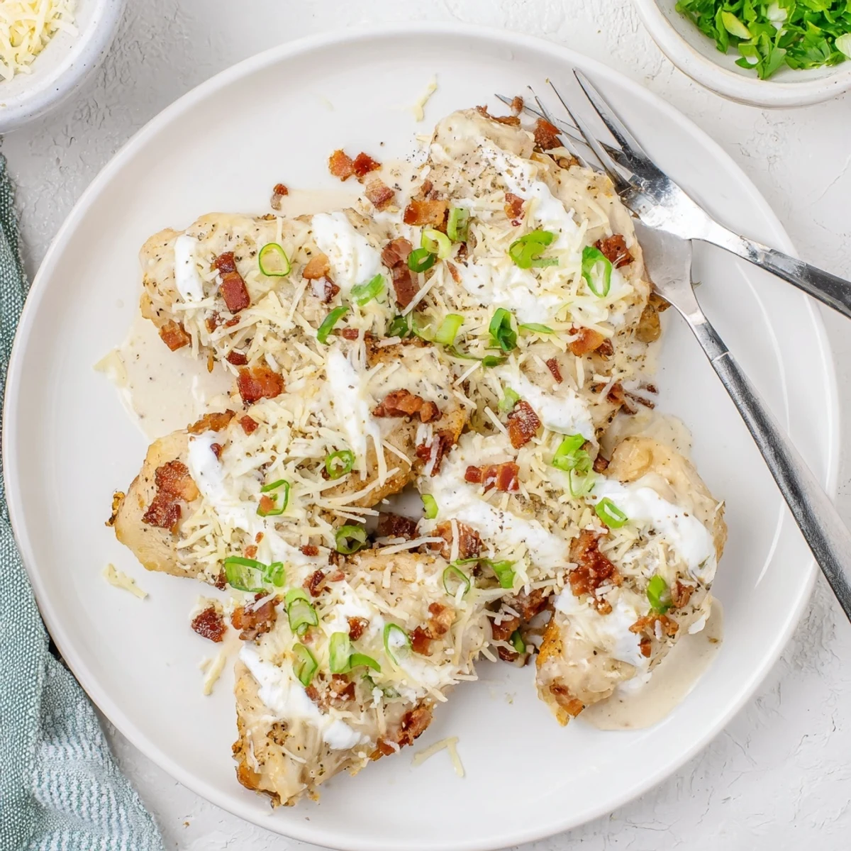 Rich Million Dollar Chicken bubbling in crockpot with parmesan cheese and bacon