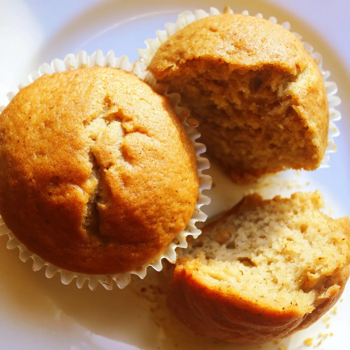 Soft banana muffins wrapped in paper liners dusted with cinnamon sugar
