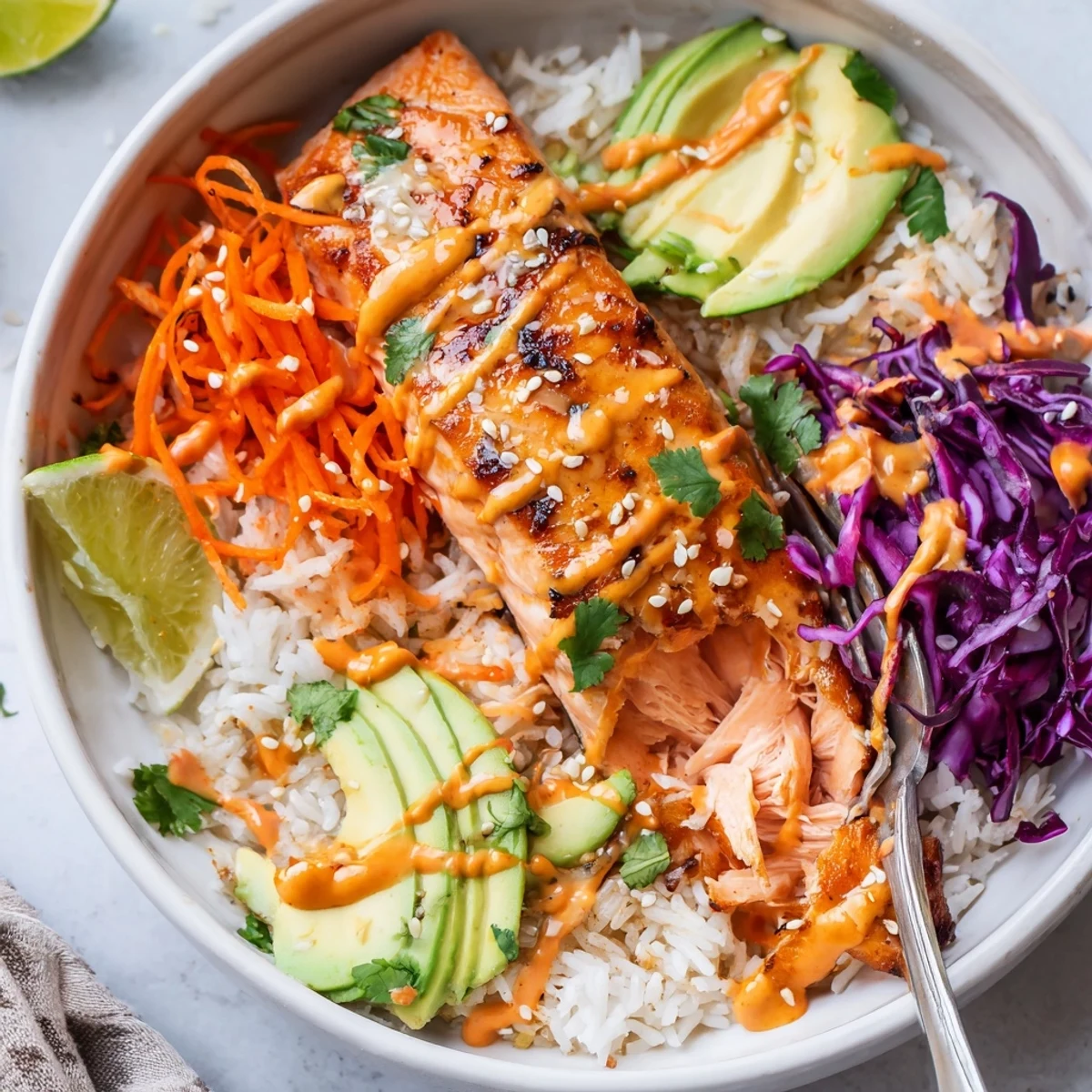 Bang Bang Salmon Bowls Recipe with roasted salmon, creamy spicy sauce and lime