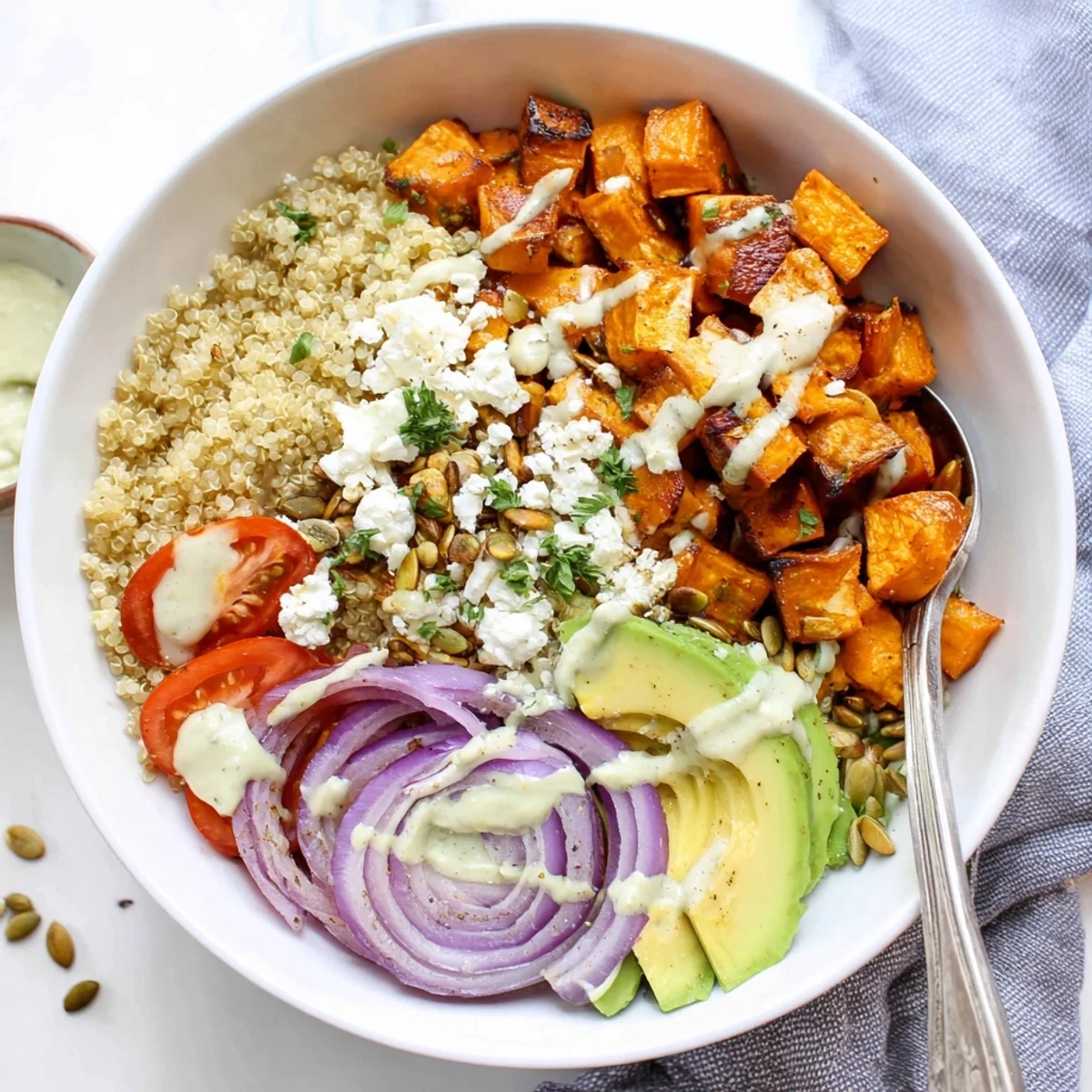 Roasted Sweet Potato Quinoa Salad Bowl with caramelized cubes, creamy avocado, lemon-tahini drizzle