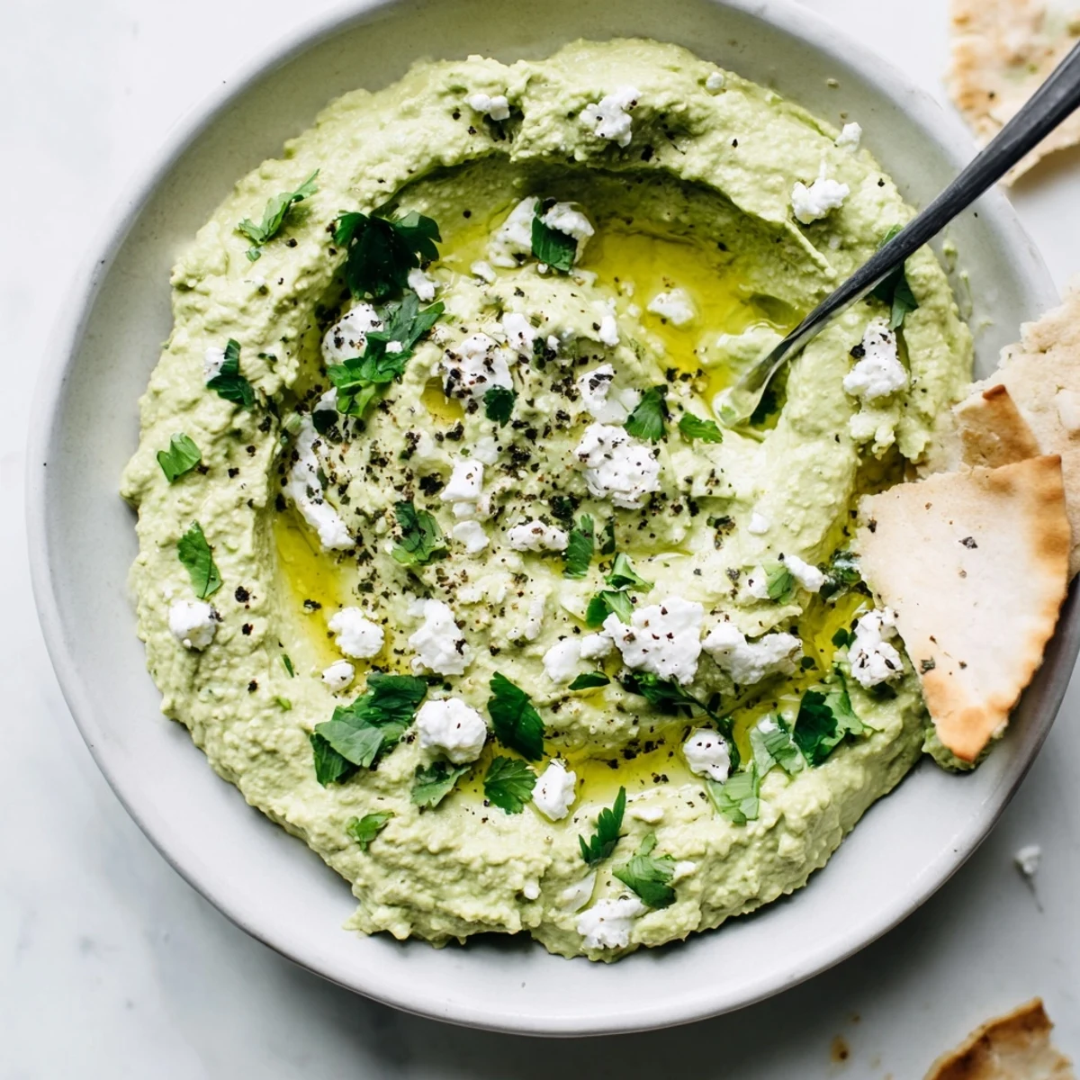 Creamy Avocado Feta Dip spoonful showing velvety green, tangy feta flecks