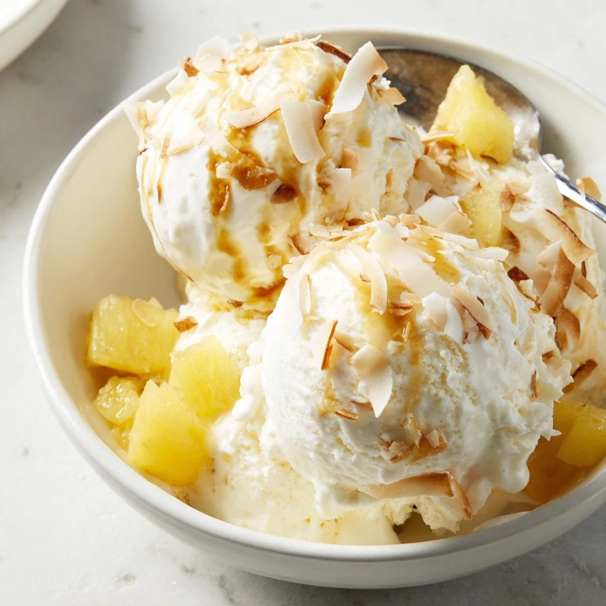 Bright Creamy Pineapple Ice Cream served with rum drizzle and fresh mint