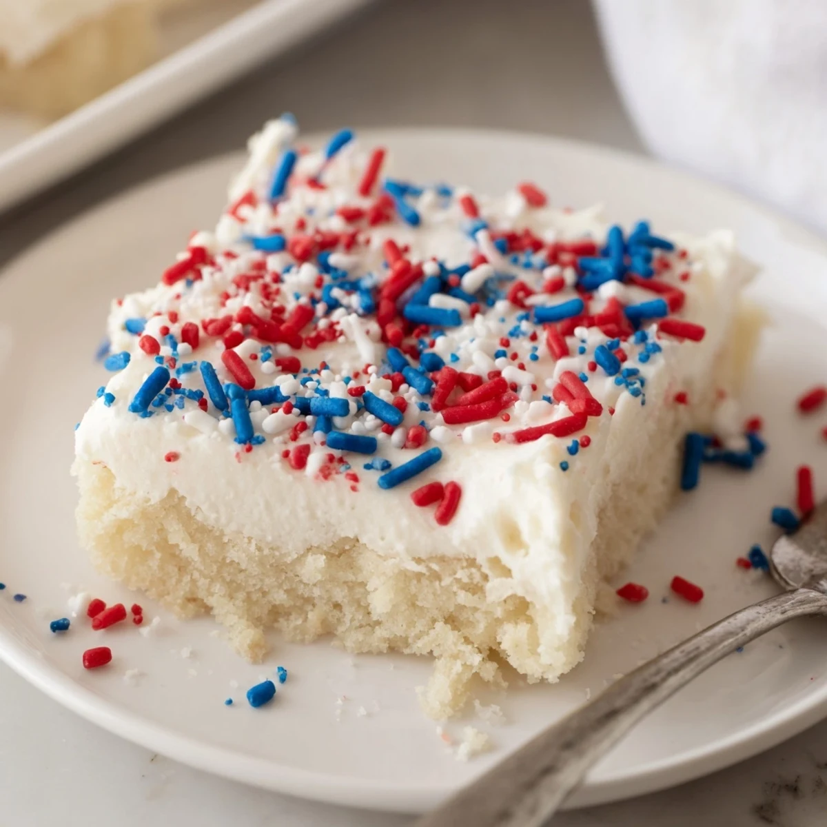 Frosted 4th Of July Sugar Cookie Bars Recipe, chilled and topped with patriotic sprinkles