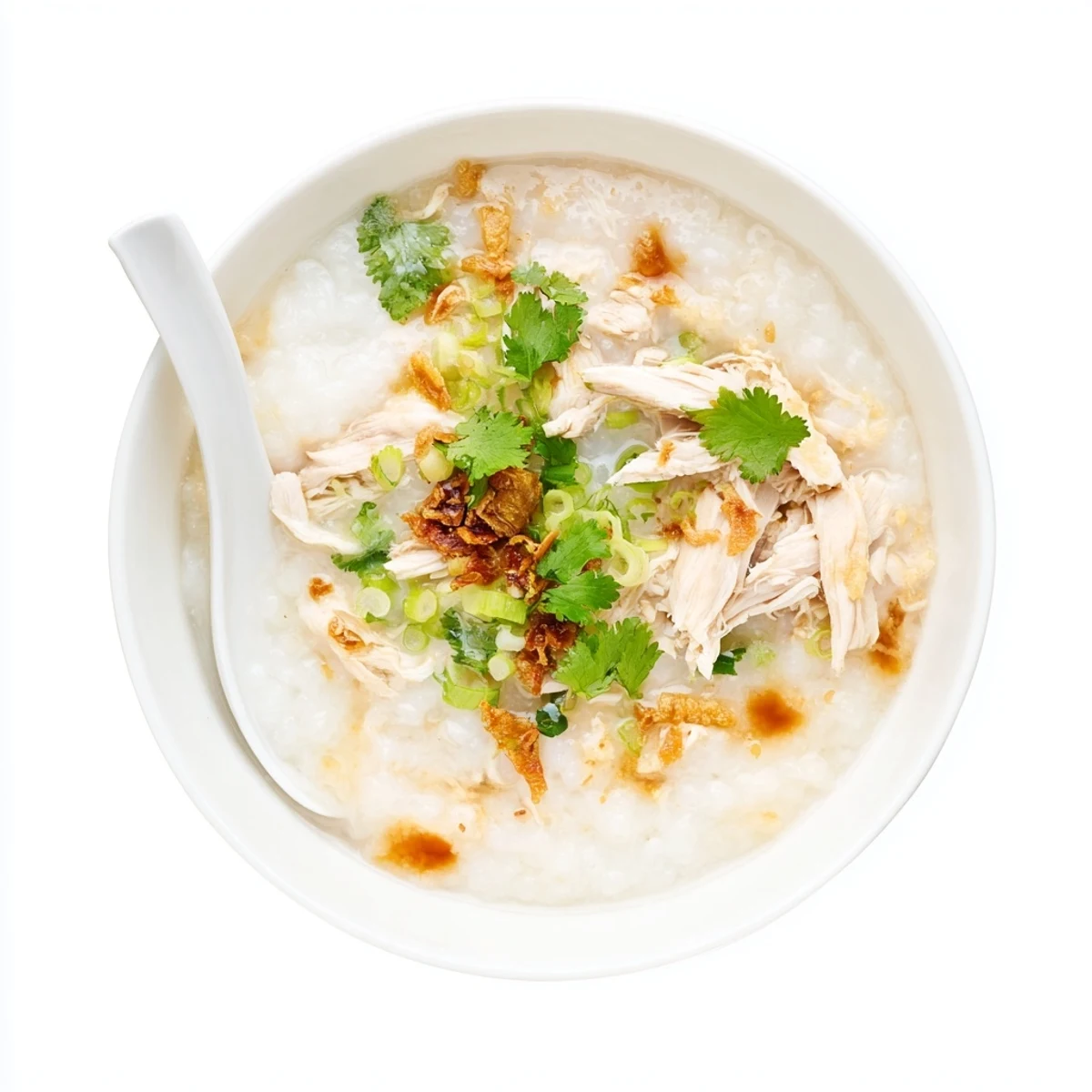 Homemade chicken congee rice porridge garnished with cilantro and served piping hot for a soothing meal