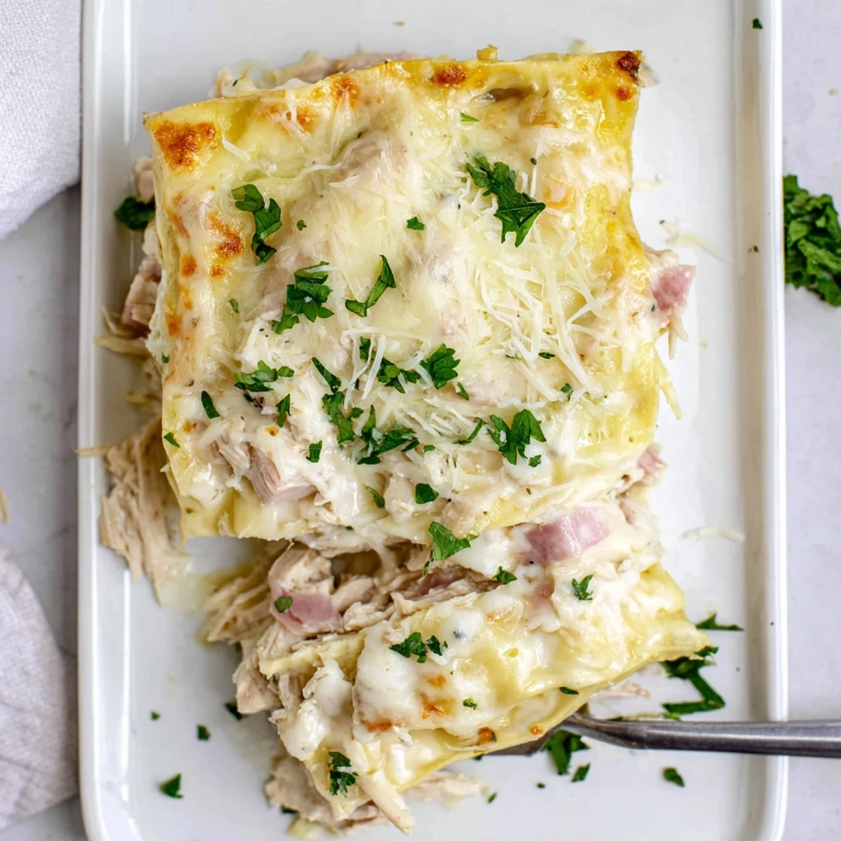 Layers of shredded chicken ham and Swiss cheese in this savory Chicken Cordon Bleu Lasagna bake